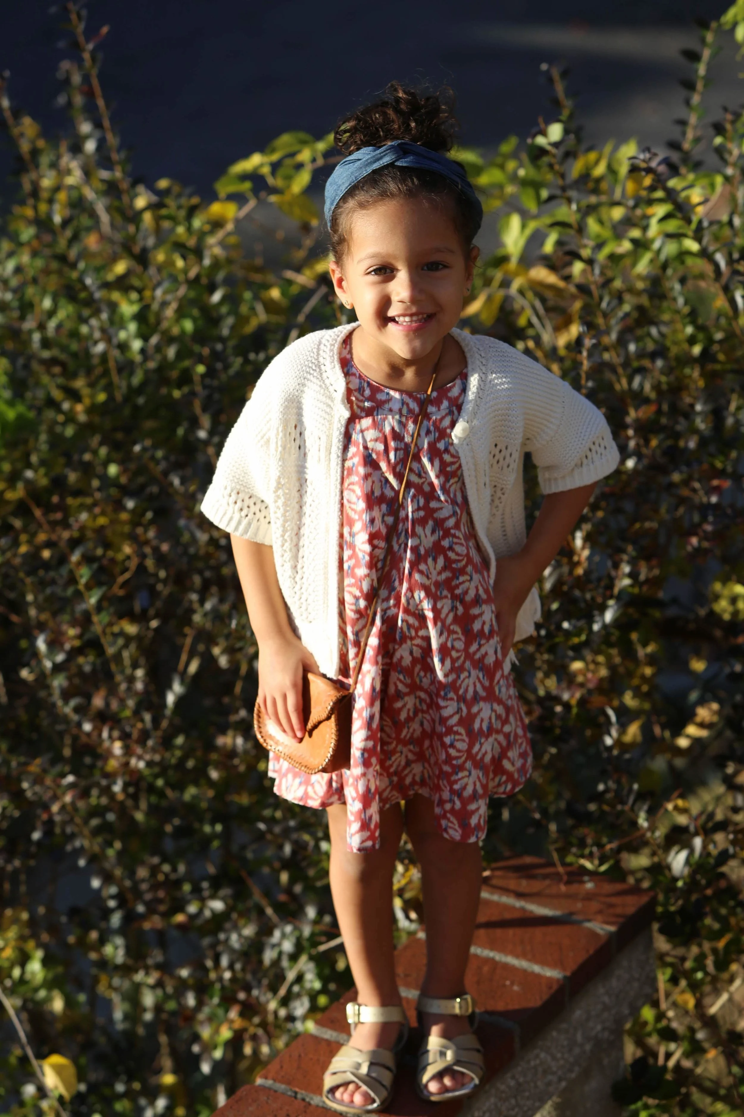Summer means flowy dresses with high buns and versatile sandals .