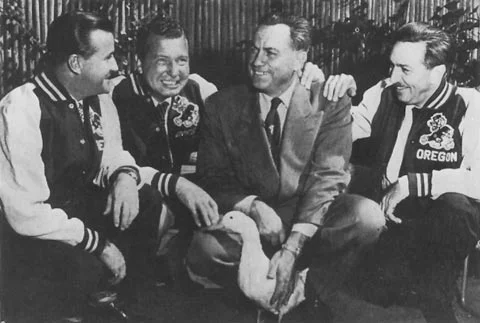 Walt Disney (right) wearing an Oregon Ducks jacket with Athletic Director Leo Harris. 