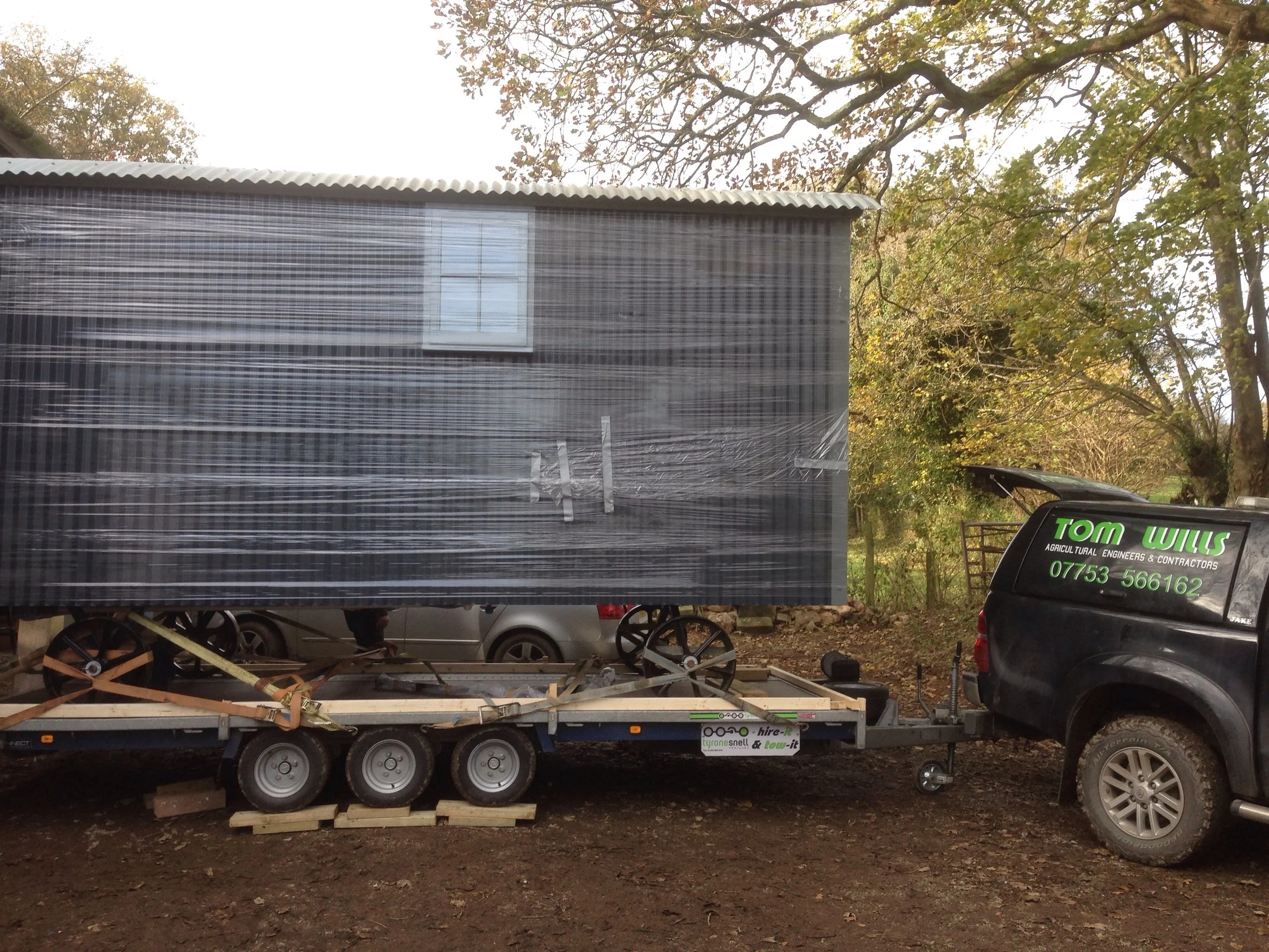 Our ever reliable delivery man Tom Wills loading up the hut