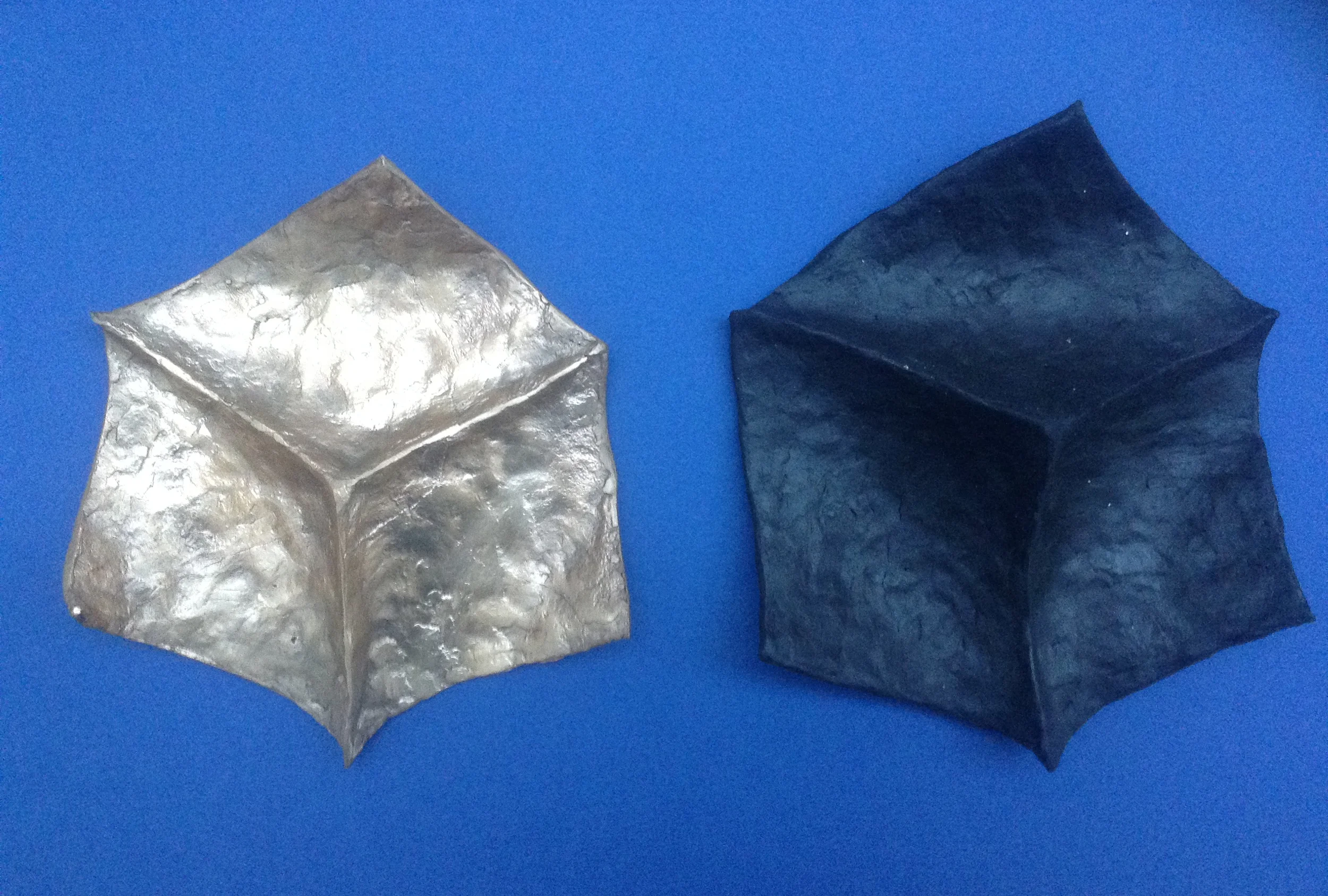 Before and after: cast bronze metal on the left, hand-molded wax on the right (black). Photo by: Mark Andrew Kelly