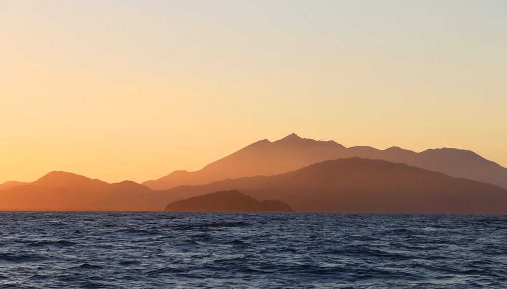 MV Monsoon sun sets over ranges.jpg