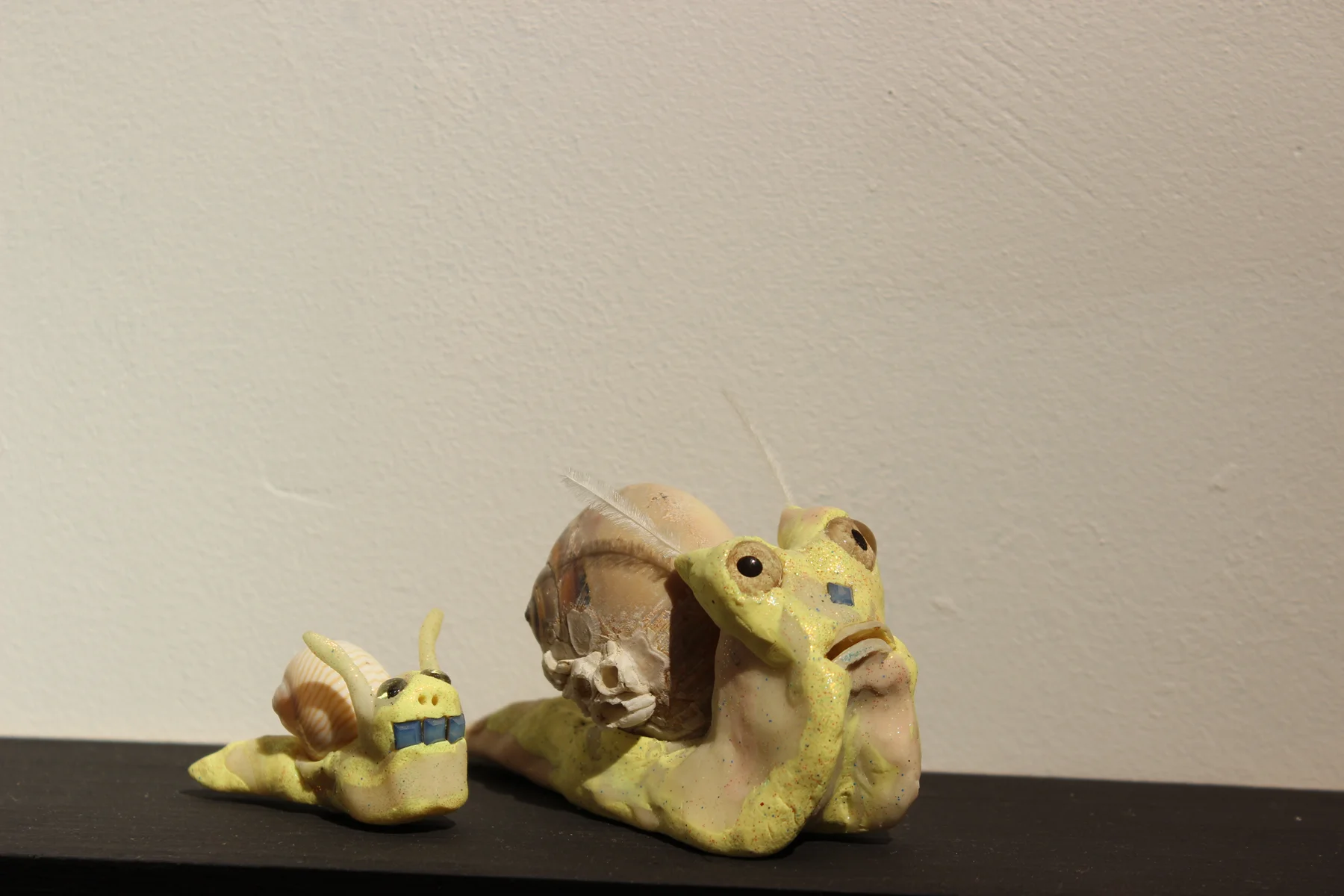 Elizabeth Ferry, Snails , Snail shell, resin, glass eyes, rhinestone, toe nail, feather, sculpey, sparkle, 2016