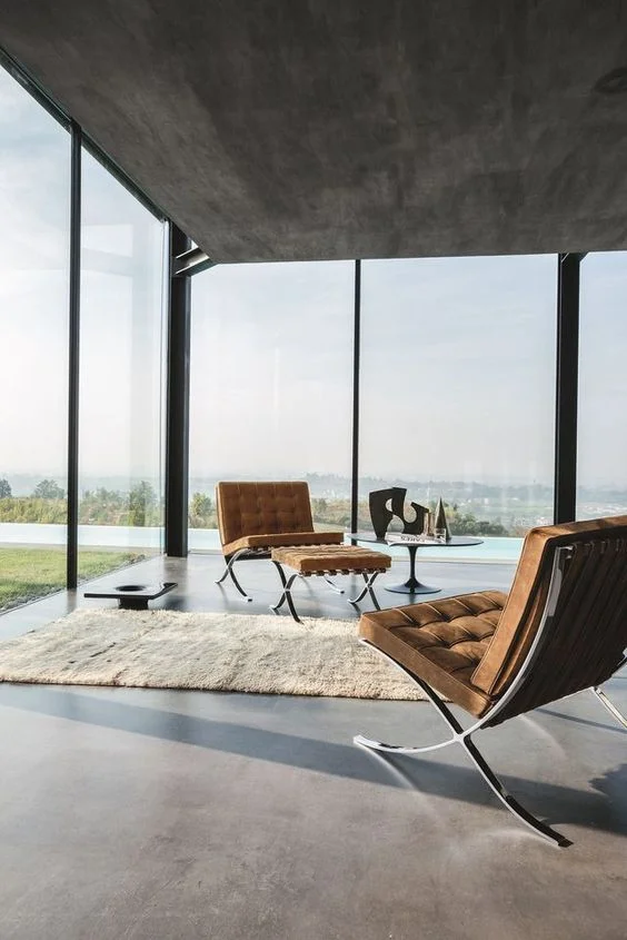 Mies van der Rohe's Barcelona armchairs and leather footrests, designed in 1929. Cortesy of Knoll/ Pinterest.