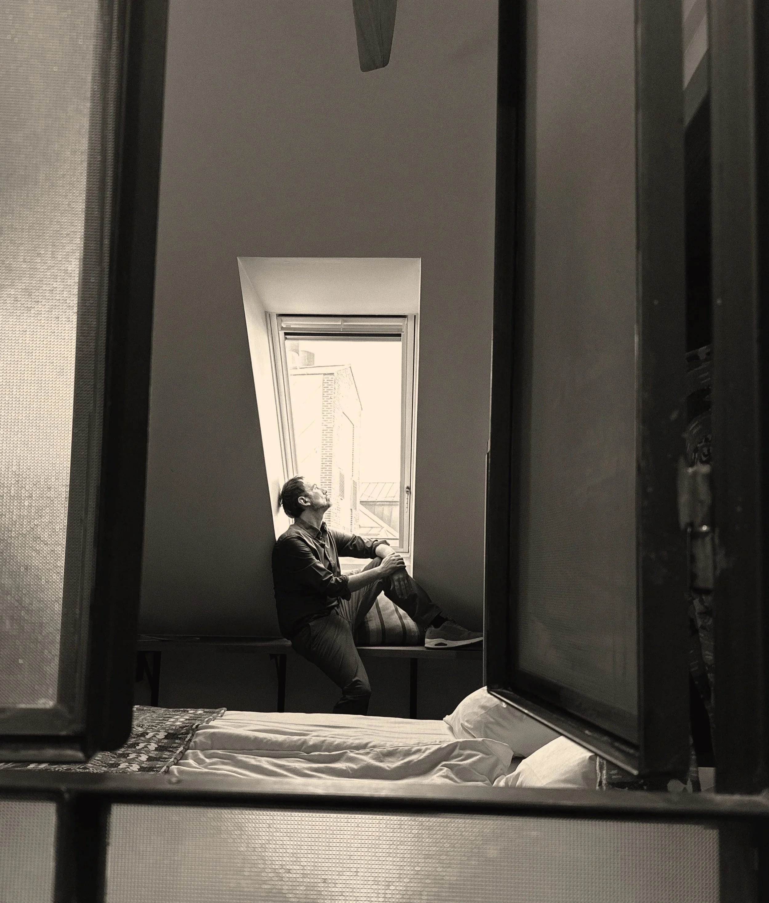 Jack Rubinacci black and white portrait sitting at a window in a hotel in Copenhagen.