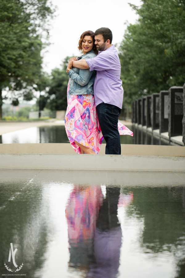 An engaged couple in Nashville, TN, with their reflection in the water 