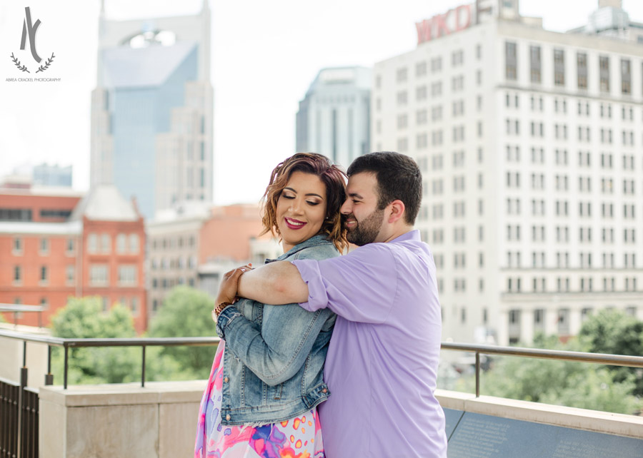 An engaged couple in front of the Nashville, Tennessee skyline