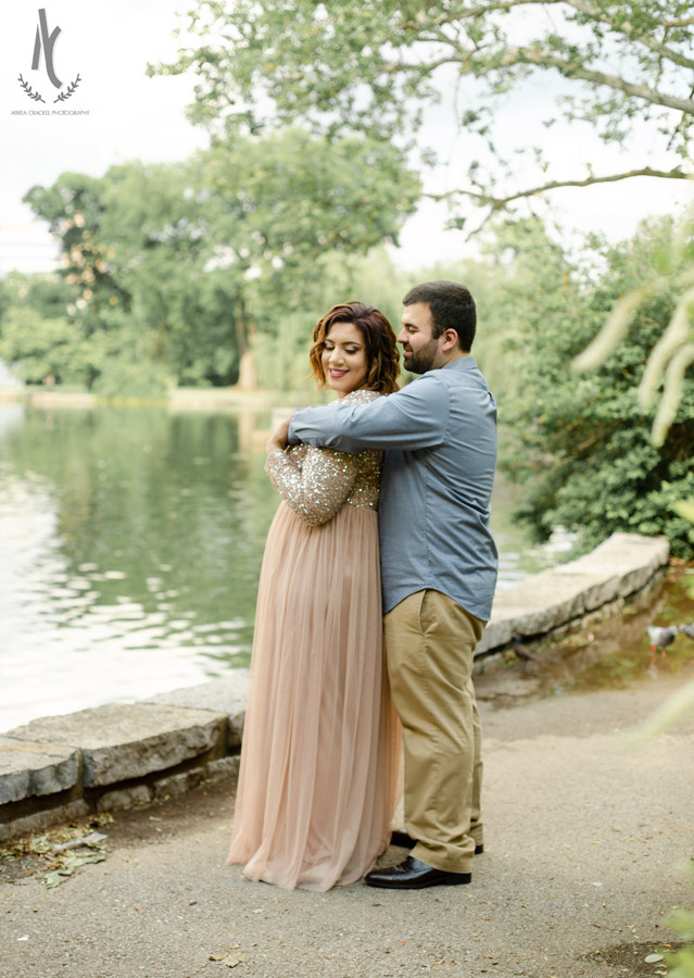 An engaged couple poses naturally at Centennial Park in Nashville, Tennessee