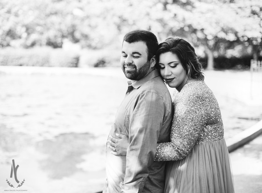 An engaged couple embracing at the pond at Centennial Park in Nashville, TN