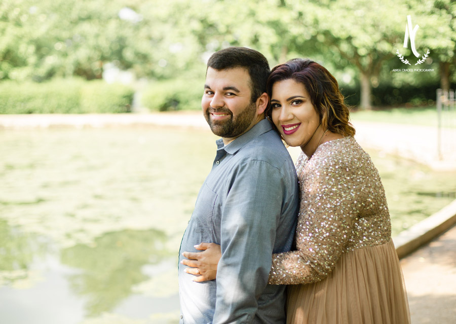 An engaged couple smiling at Centennial Park in Nashville, Tennessee