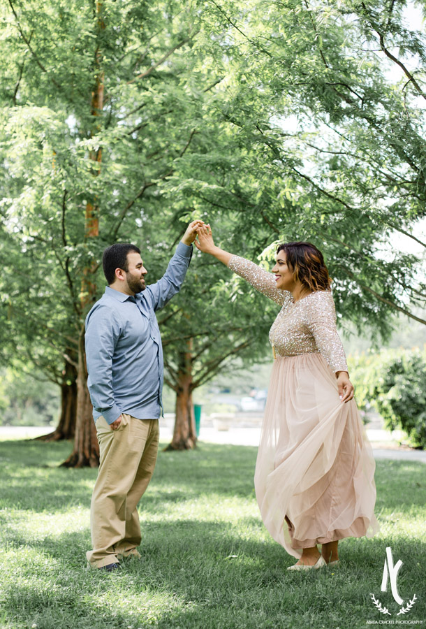 A twirling dance picture of an engaged couple at Centennial Park in Nashville TN
