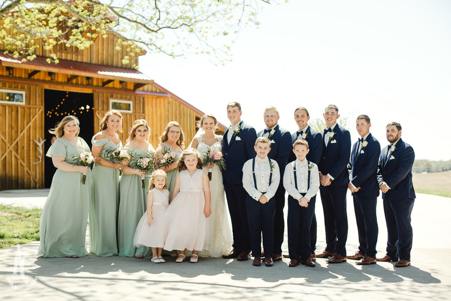 Teal bridesmaid dresses and navy suits for the groomsmen. 