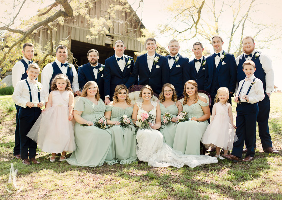 Wedding party in navy and teal with suspenders. 