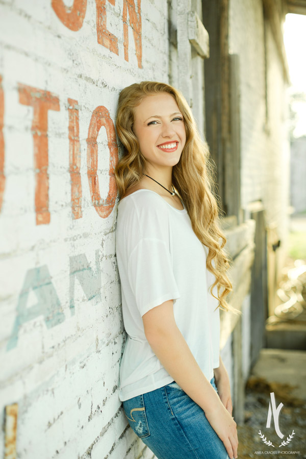 High School Senior leaning against a wall at Downtown Martin, Tennessee