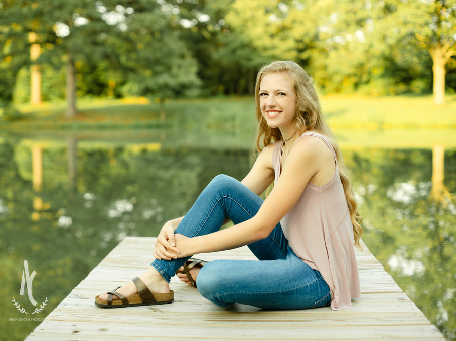 High School senior from Martin, Tennessee, sitting on dock at a pond