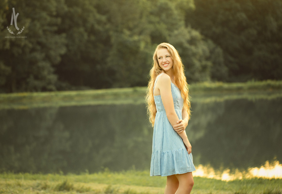 High School senior standing in front of pond at sunset in Martin Tennessee