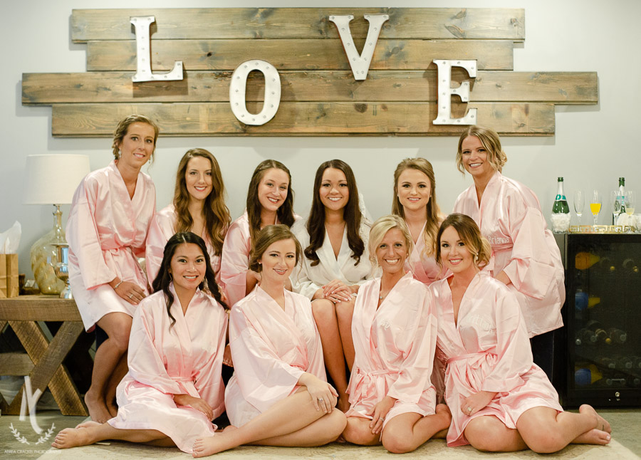 Bridesmaids and bride with monogrammed pink robes 