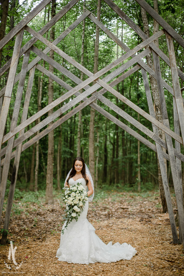 Bride under geometric awning in woods 