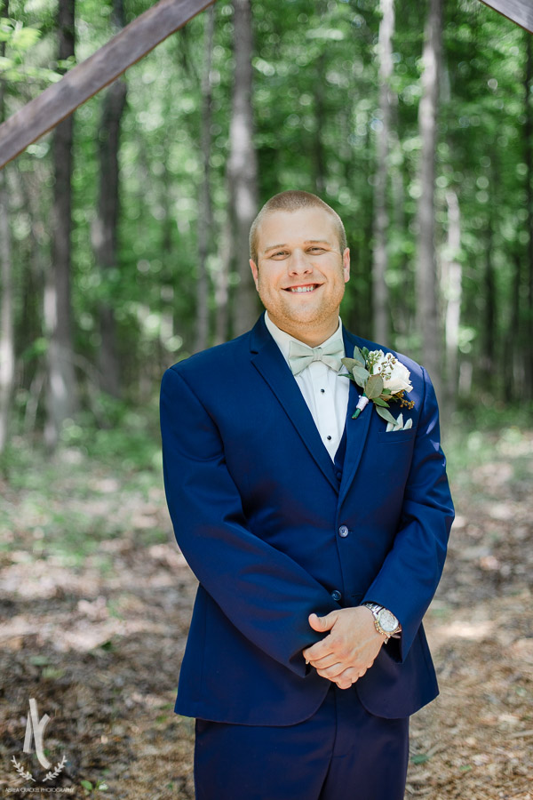 Groom in navy suit on wedding day 