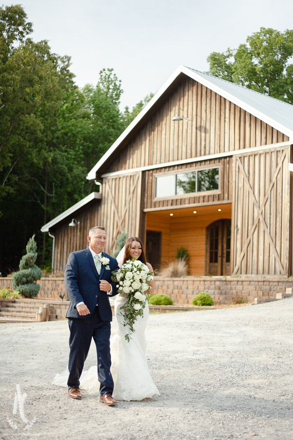Bride & Dad walk up to ceremony at K&M Barn at Lewis Farms 