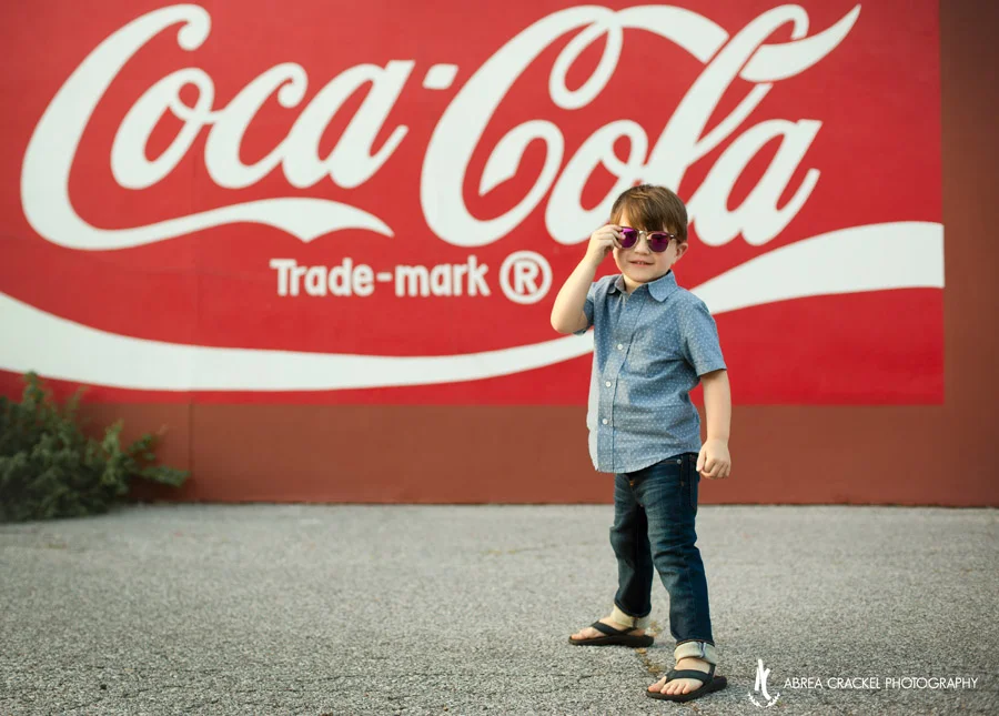 Urban Coca-Cola graffiti behind toddler boy