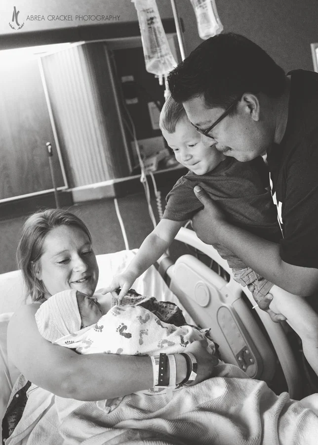 Big brother Esau saying hello to his baby sister for the first time