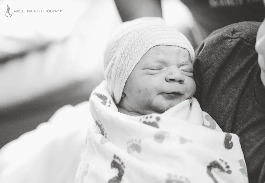 Baby Evy was cozy in her big brother's arms