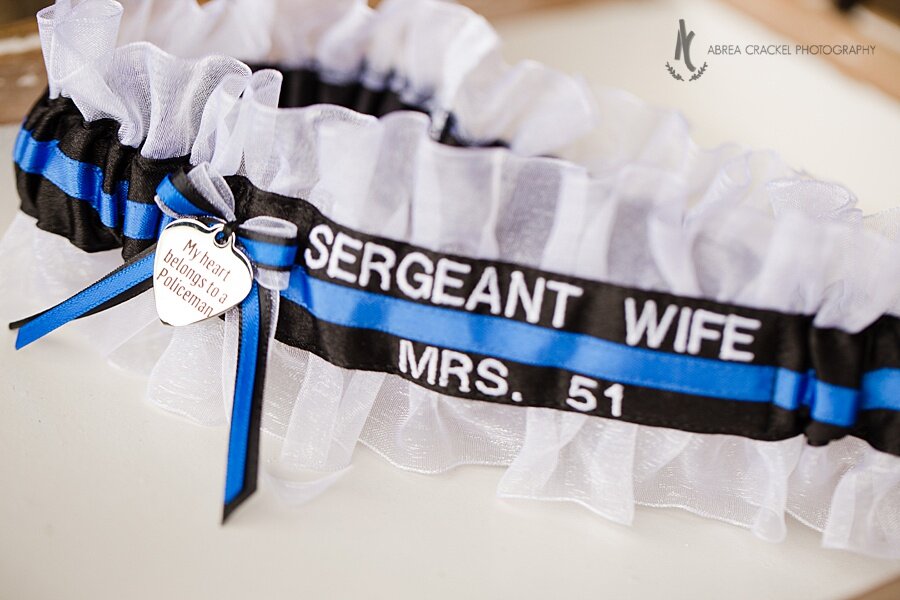  I love all the special, personal touches that were incorporated into this wedding! Eric is a sergeant at the police department, so Becky had this garter custom made just for him.  