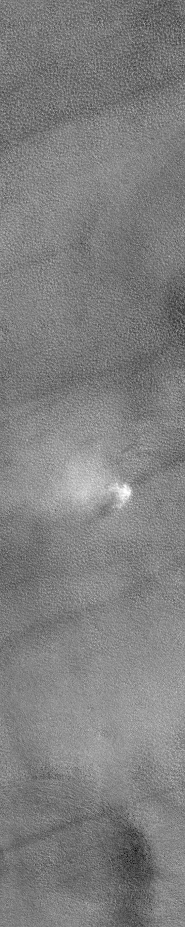 That fuzzy bright thing is a growing dust devil caught by the HiRISE camera orbiting Mars! Image credit: HiRISE/ASU.