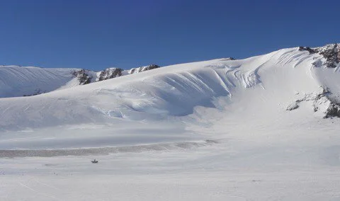 Amazing Antarctic ice mountains! Bottom-center is a skidoo for size reference! Image credit: ANSMET