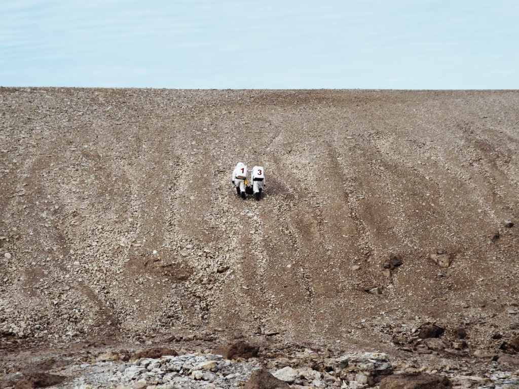 Crewmembers after a long day of geologic sampling of Devon Island and testing custom spacesuits for their study. Image credit: FMARS/Mars Society