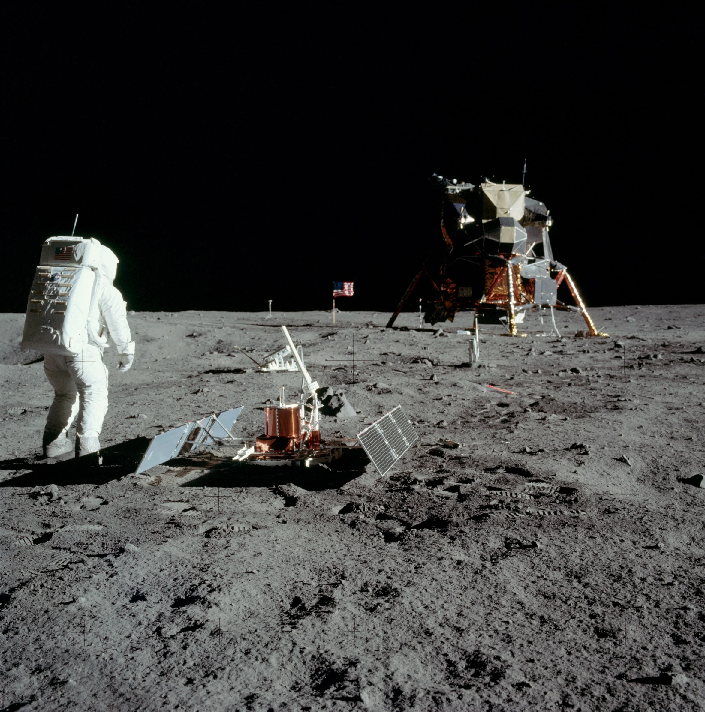 Apollo 11 astronaut Buzz Aldrin with the seismic experiment. Solar panels have deployed on the left and right and the antenna is pointed at Earth. Image credit: NASA