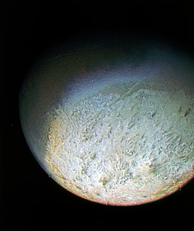 Triton, Neptune’s captured moon, as imaged by Voyager 2. Image credit: NASA/JPL