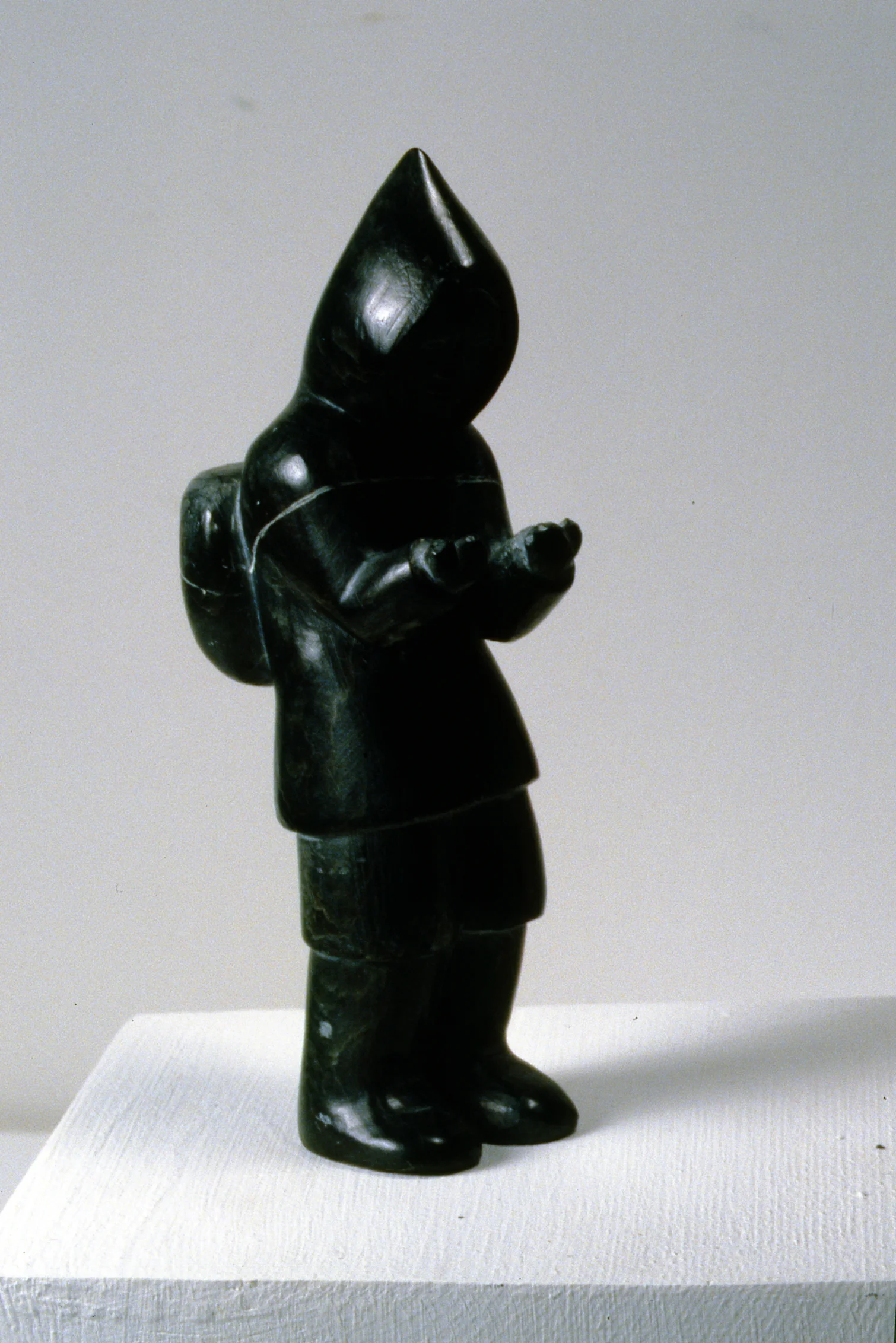 Man Carrying Pack, n.d., Noah Arnaquq, carved stone, 15.2 x 6 x 4.5cm, 1998.01.31