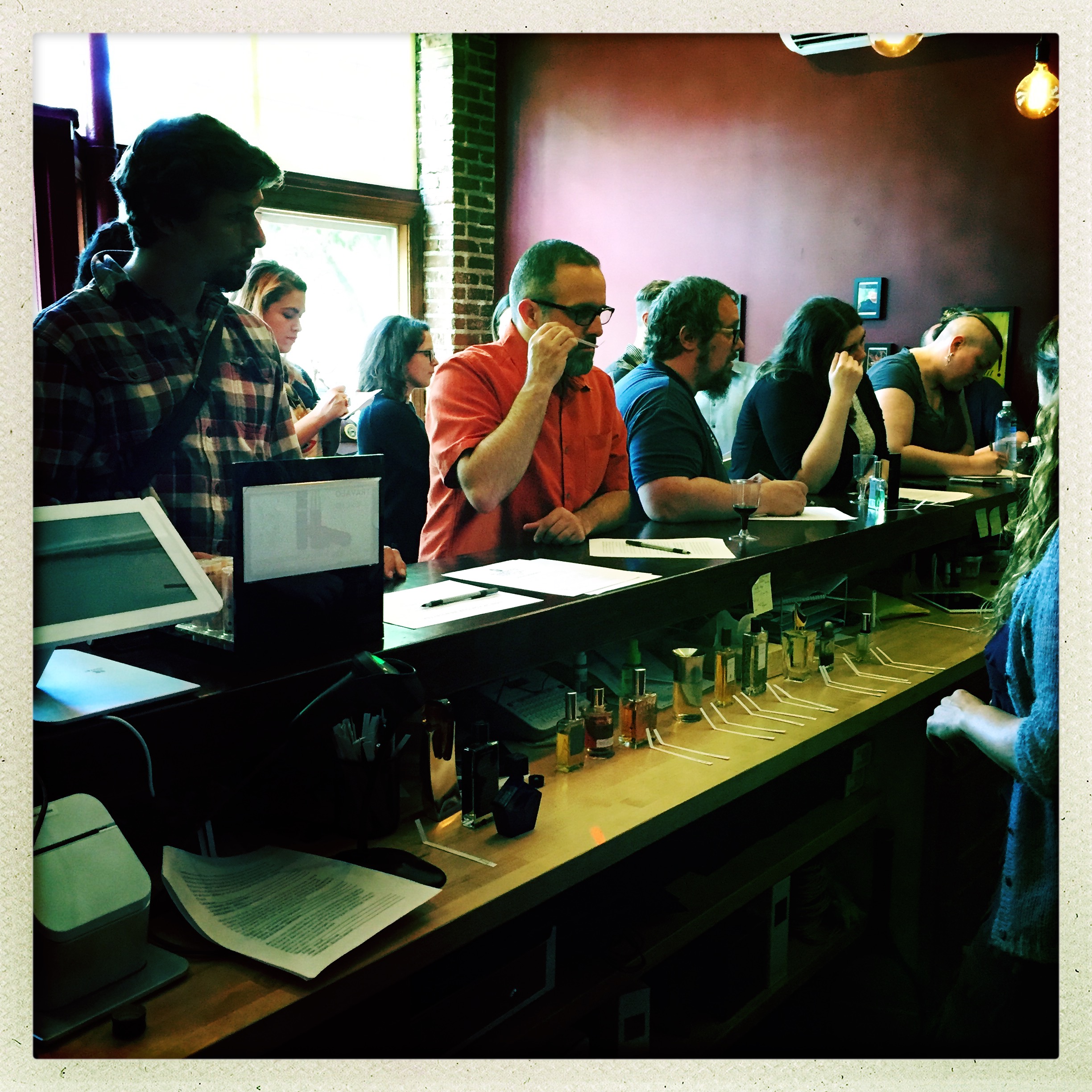 A view from behind the bar; in the foreground you can see the featured fragrances with smelling strips lined up and ready to be passed around to attendees.