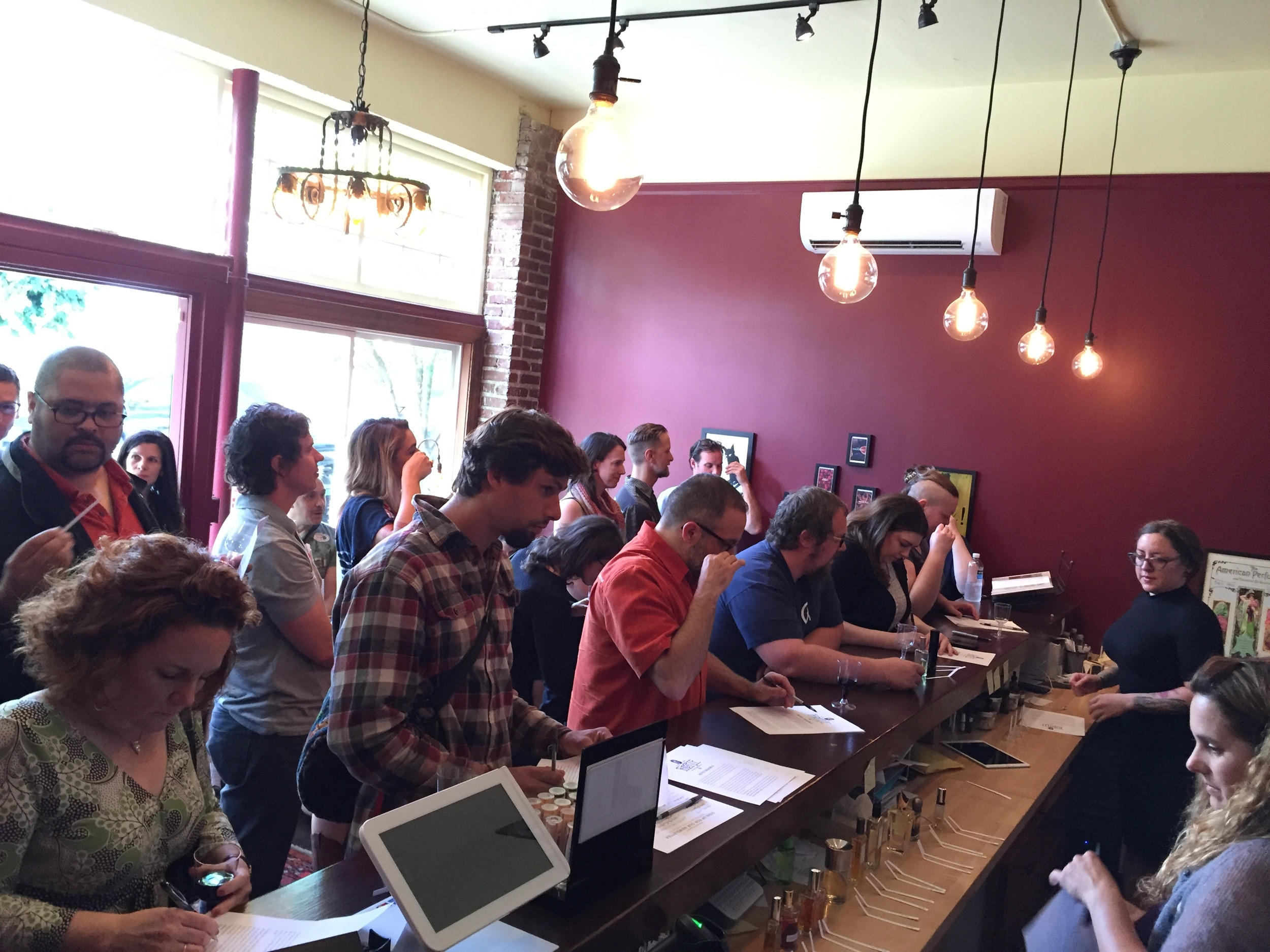 In the foreground attendees record their impressions while Tracy and Nicole look on.