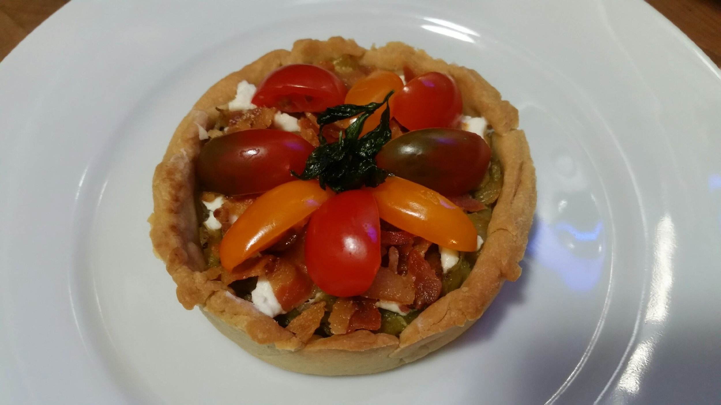 Leek, bacon, goat cheese and tomato  tartlet.