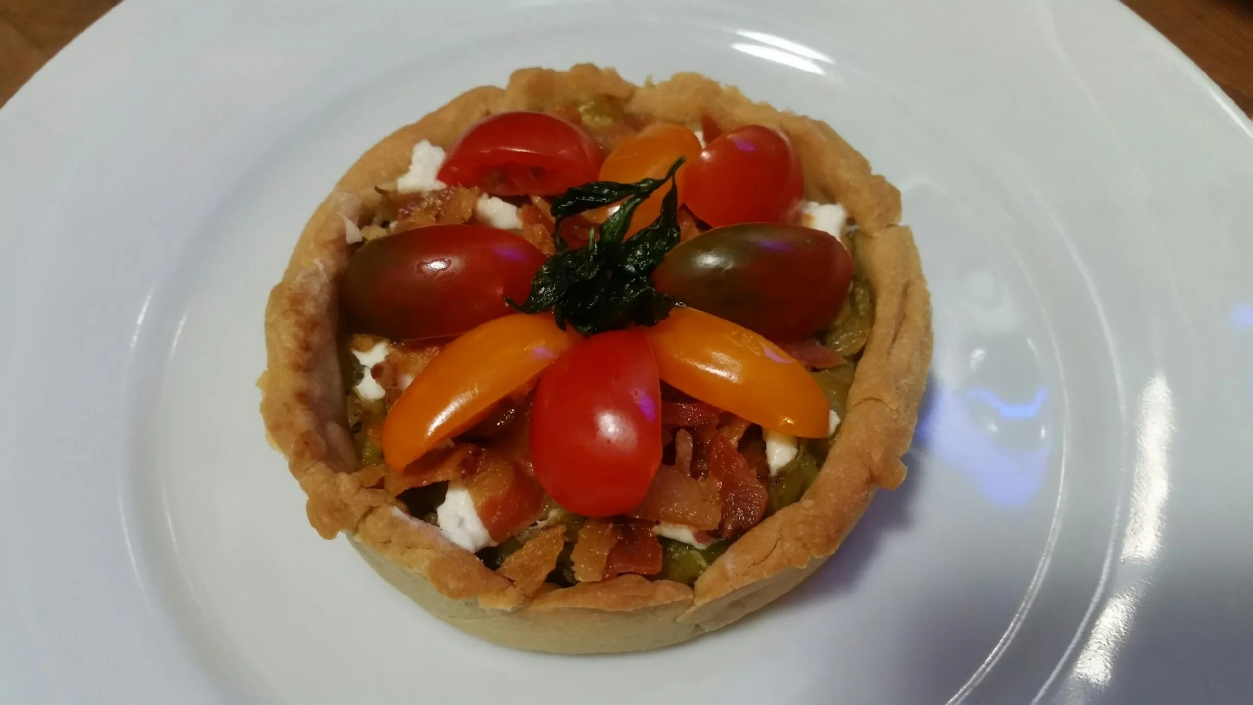 Leek, bacon, goat cheese and tomato tartlet.