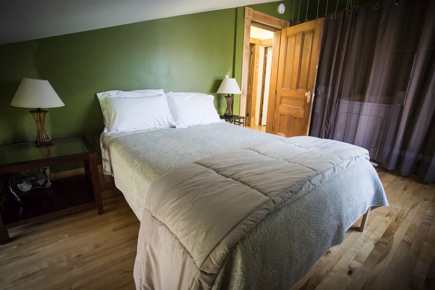 Left Wing Garden bedroom with views of Mt. Philo, and northern lake. Washer/dryer in room behind the curtain