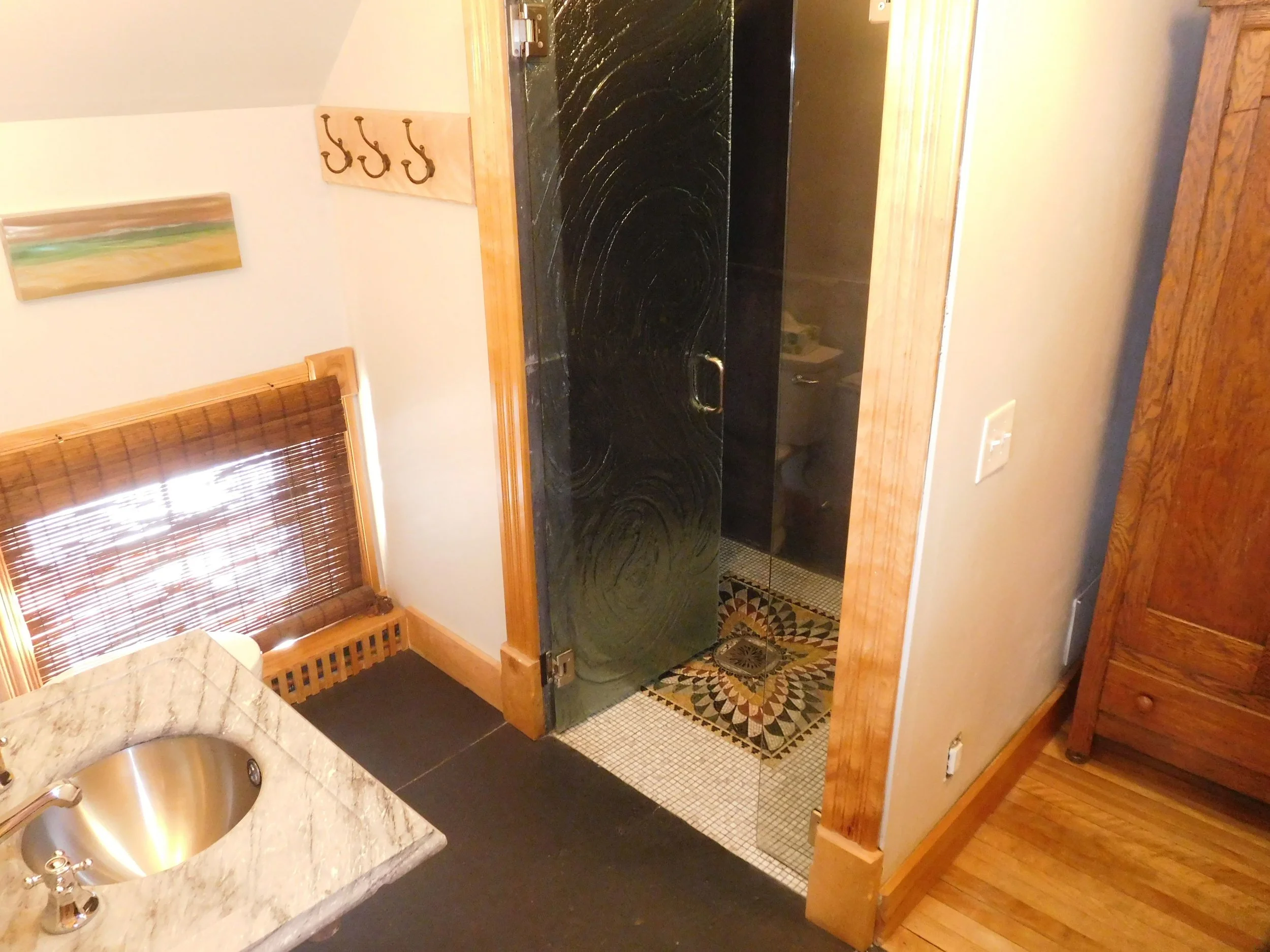 Carriage House downstairs bathroom. Steam shower, mosaic tiled floor, pressed glass door