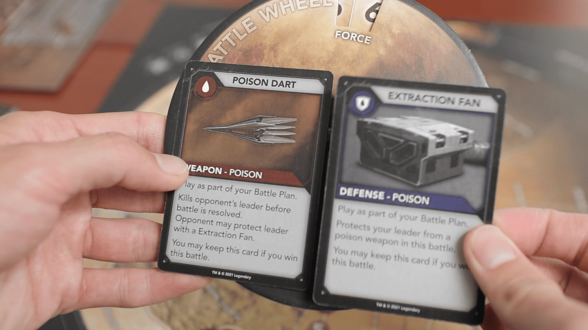   Playing an offense and defense card with the battle wheels in Dune Conquest.  