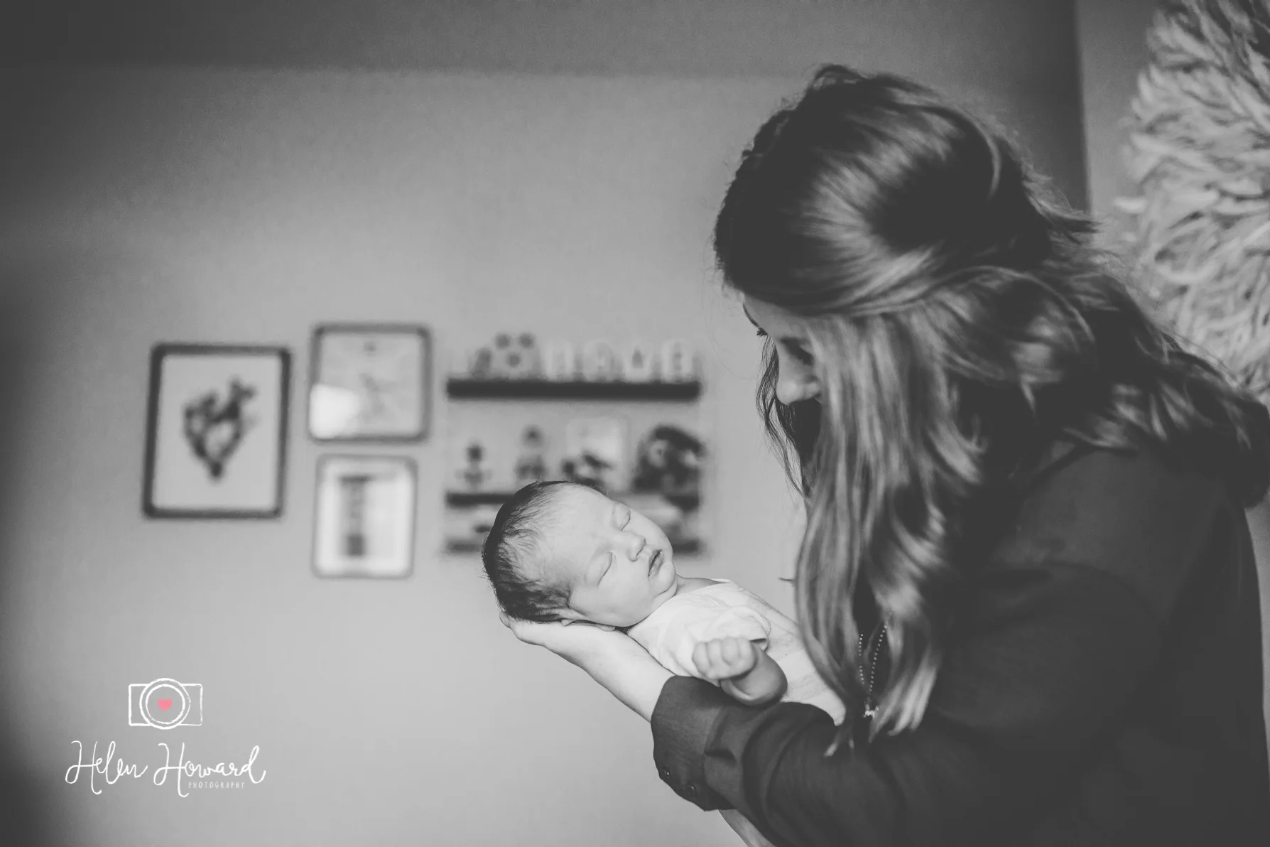 Black and white image of a mother holding her newborn baby girl