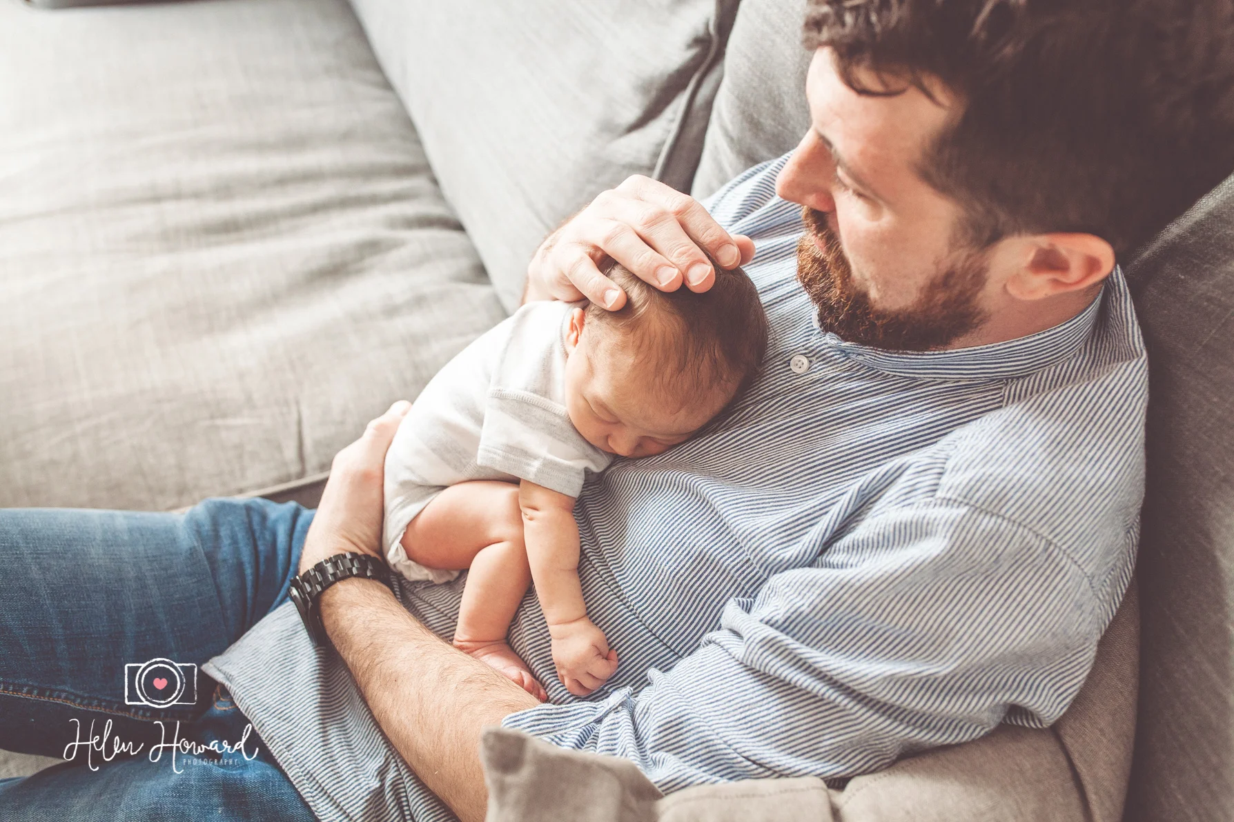 Newborn baby asleep in her father's arms