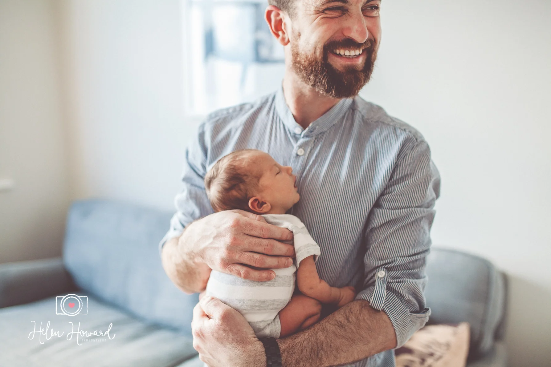 A dad holding his newborn baby portrait photography in Lichfield