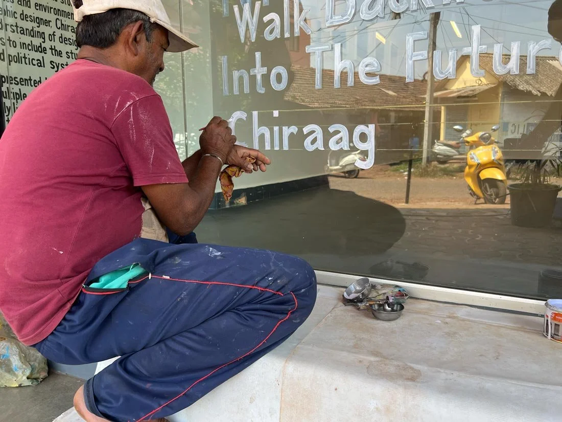 (2025) Sign painter, Pradeep Desai, hand letters the title and information around my solo show  "Walk Backwards Into The Future"  at HH Spaces in Goa, India