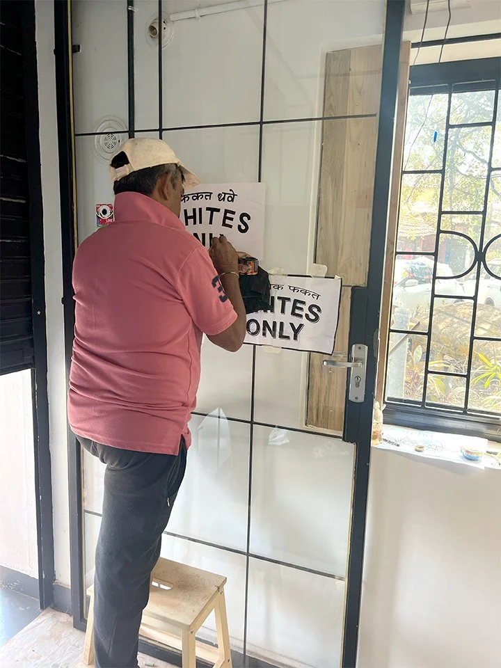  Trojan Horse (Whites Only, A/C),  2025, Oil based paint on glass door; 16" x16"
 —
 Goa, India
 —
 Addressing whiteness, gentrification, and the role that art plays in it.