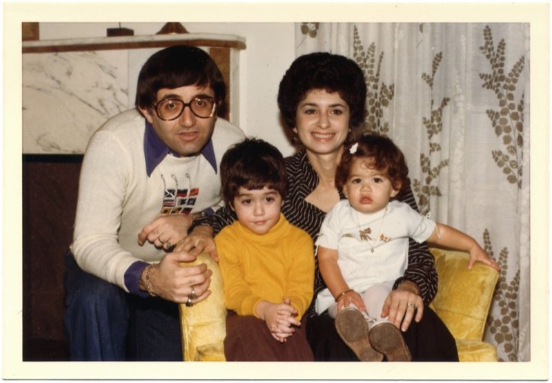 Two white adults with two small children.