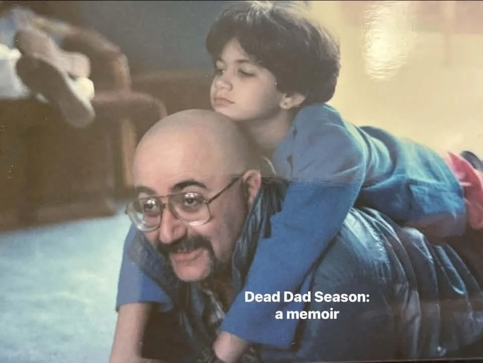 A white girl on the shoulders of her white father.