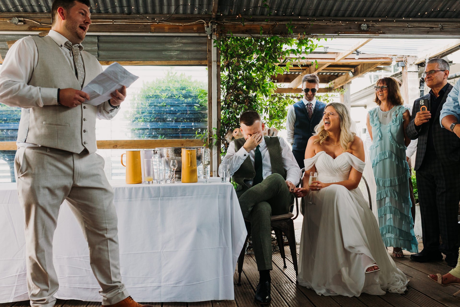 bride-groom-speeches-head-in- hands-laughing.jpg