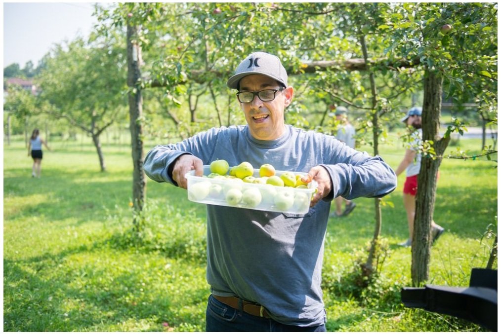 Andrew S. proudly holds up the apples he picked in Soltane’s orchard on our campus in Glenmoore, PA.