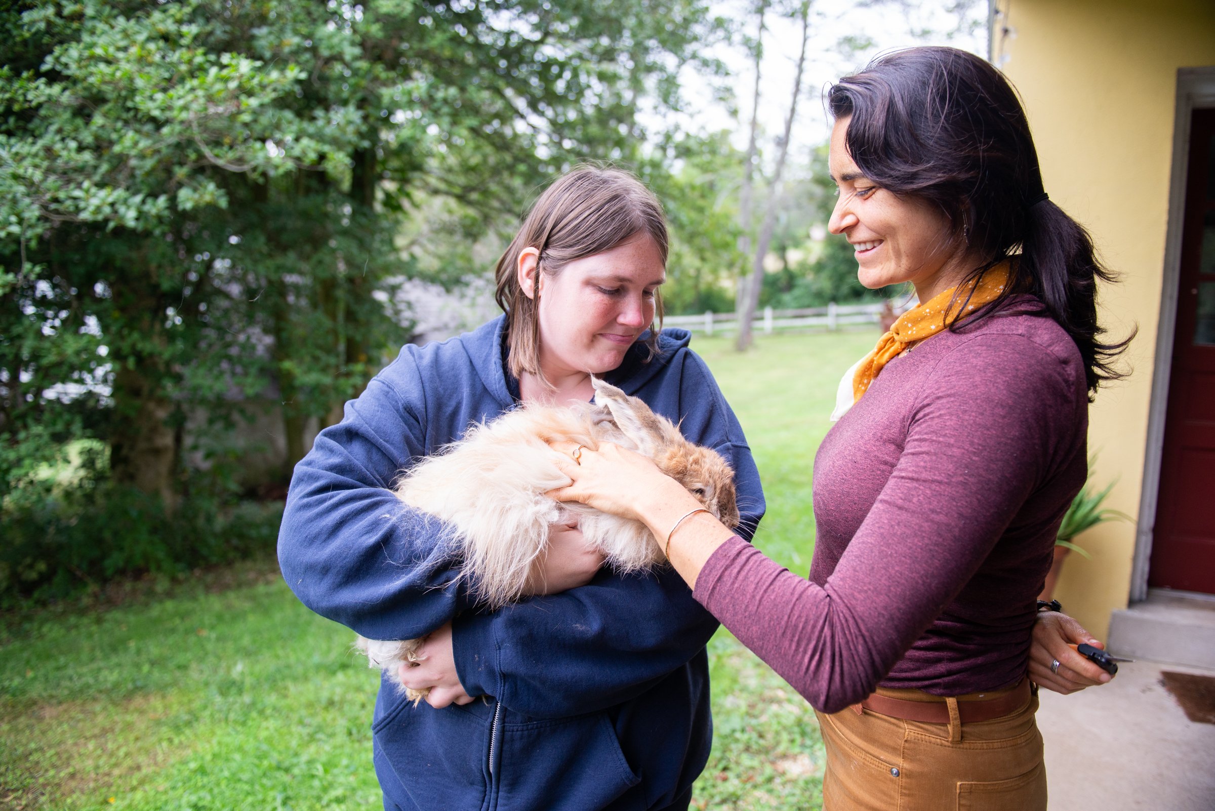 Helen K-R and Alyssa Scarborough, Land Planning and Protection Director, caring for Soltane's angora rabbit.